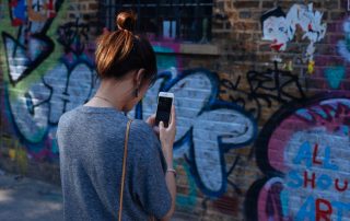 A brick wall covered in graffiti.